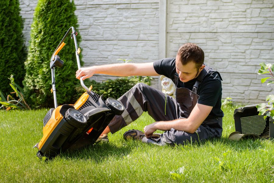 A man checking a lawn mower