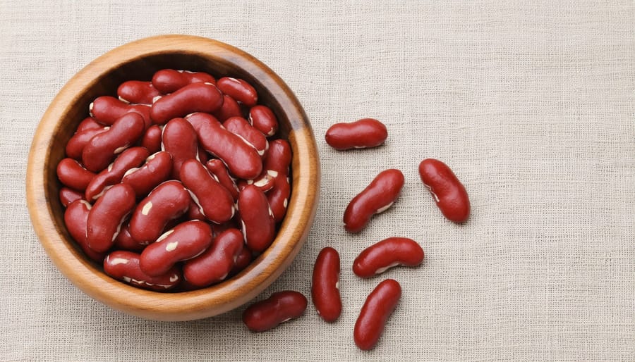 Organic red kidney beans in a wooden bowl showing their rich color and texture